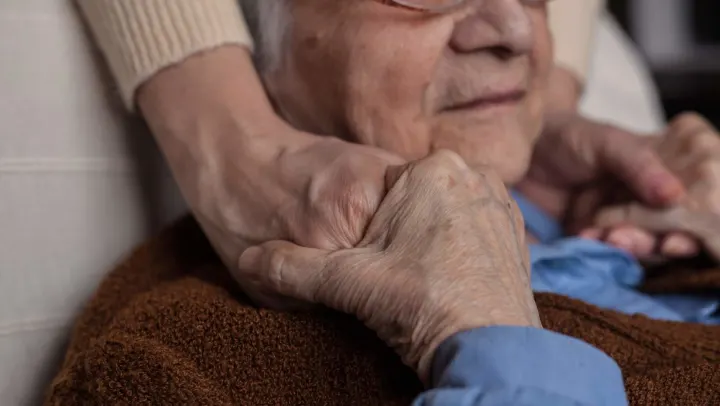 senior holding hands with someone